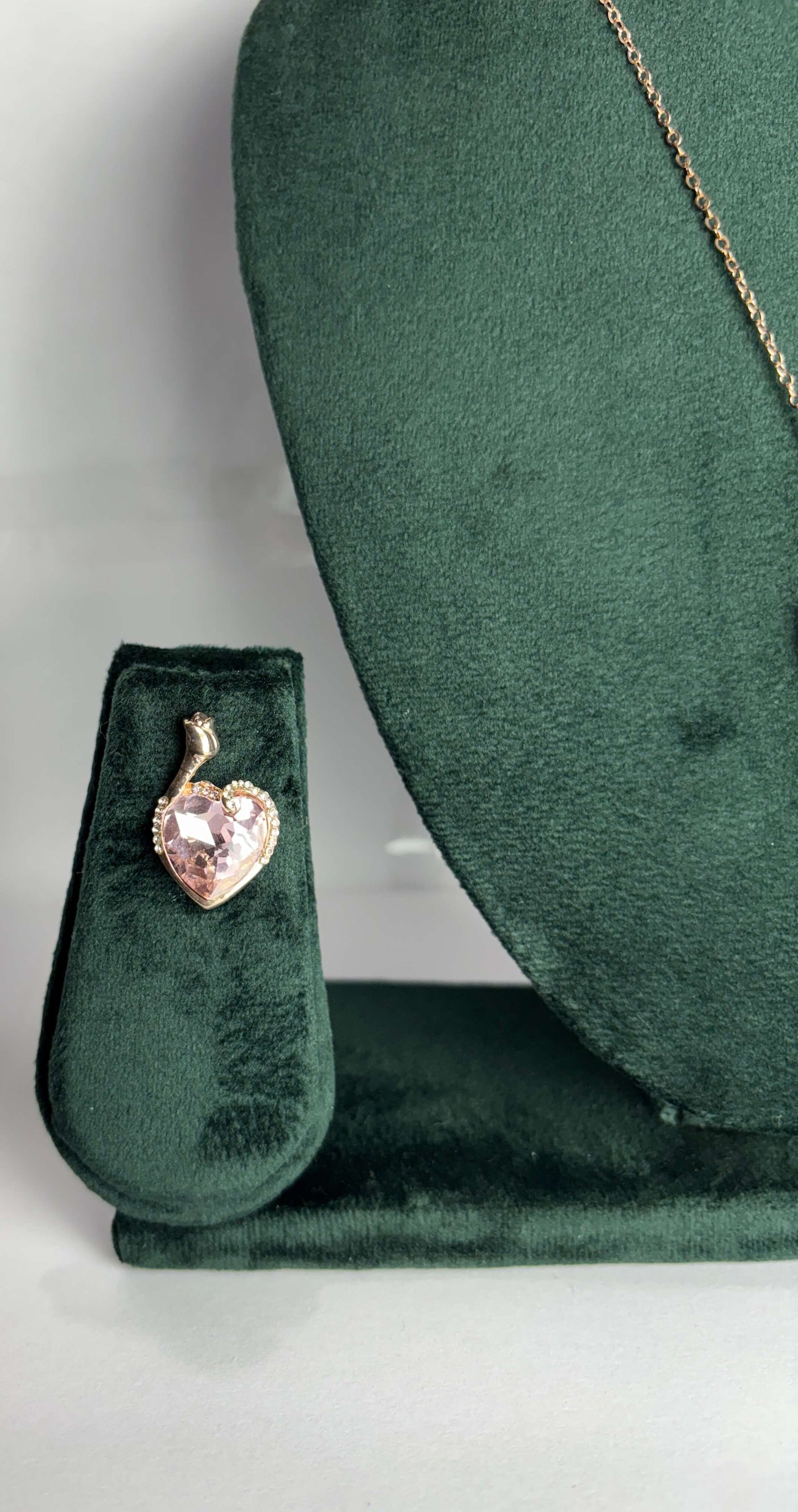 Heart-shaped pink gemstone pendant on a gold chain