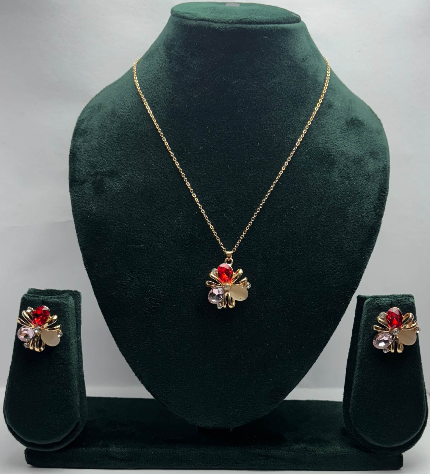 Jewelry set with necklace and earrings with red and clear gemstones