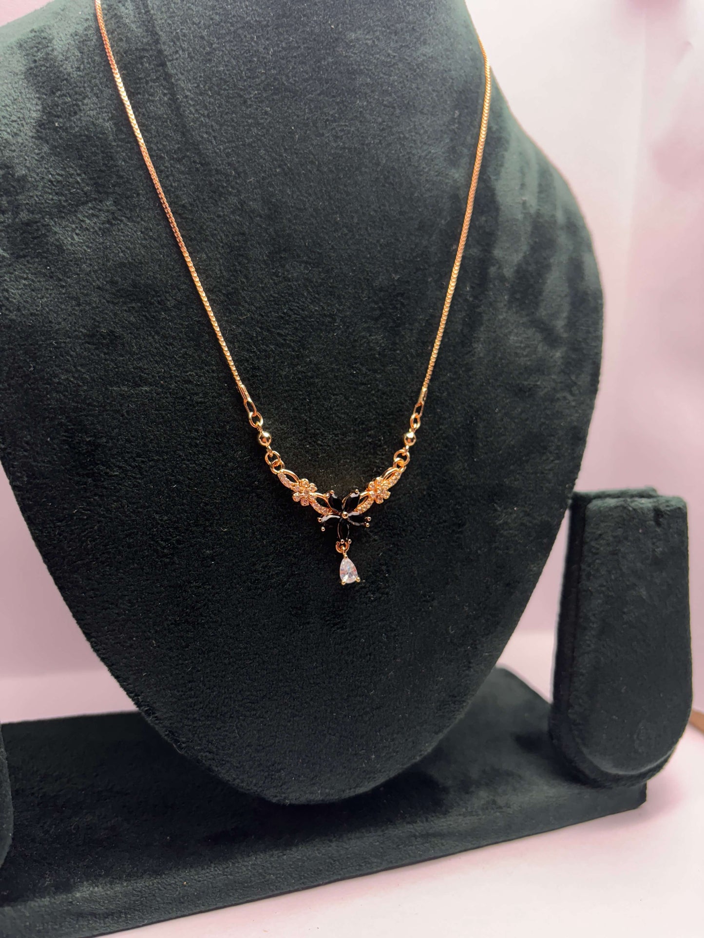 Gold necklace with black flower