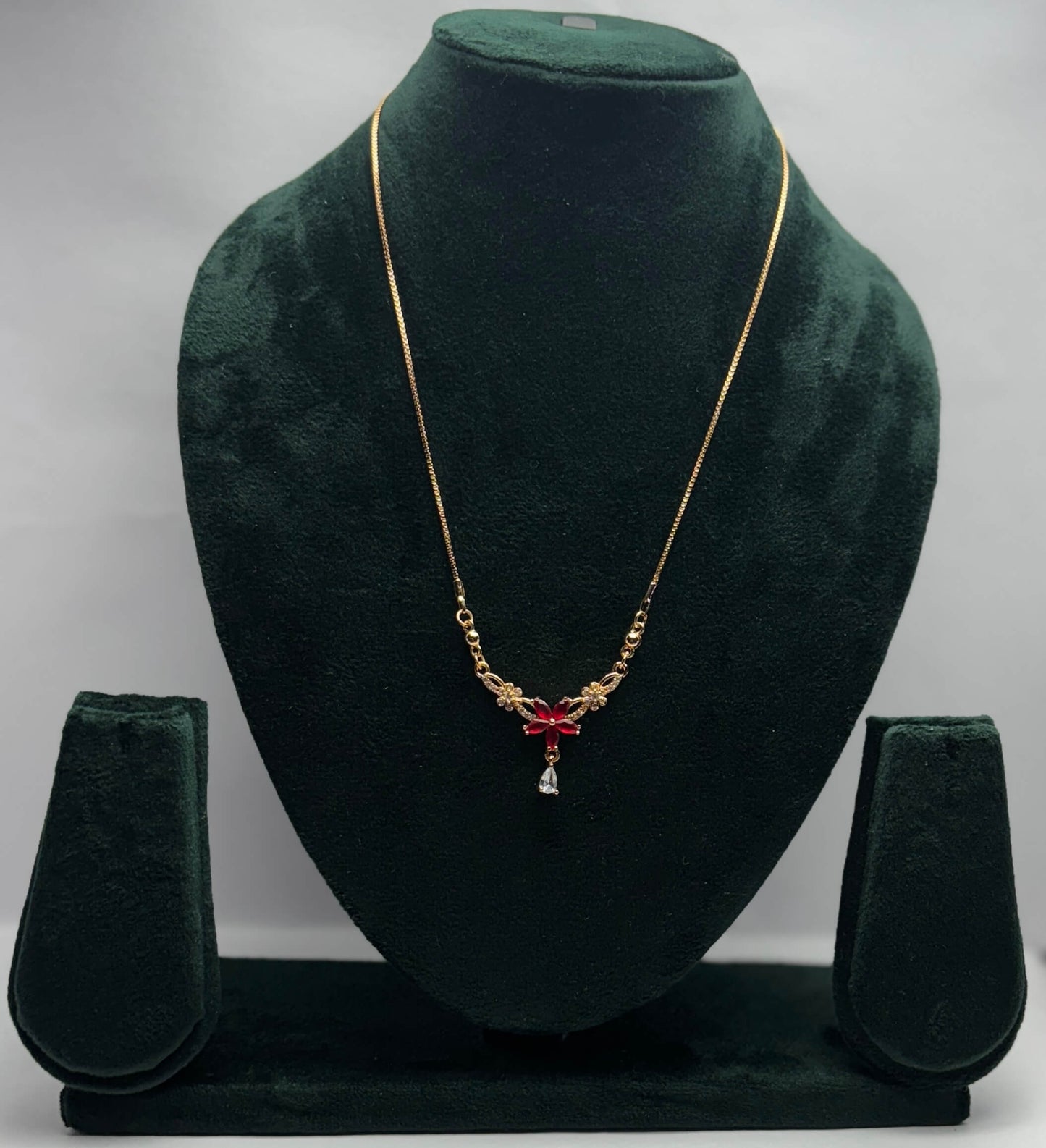 Gold necklace with red flower