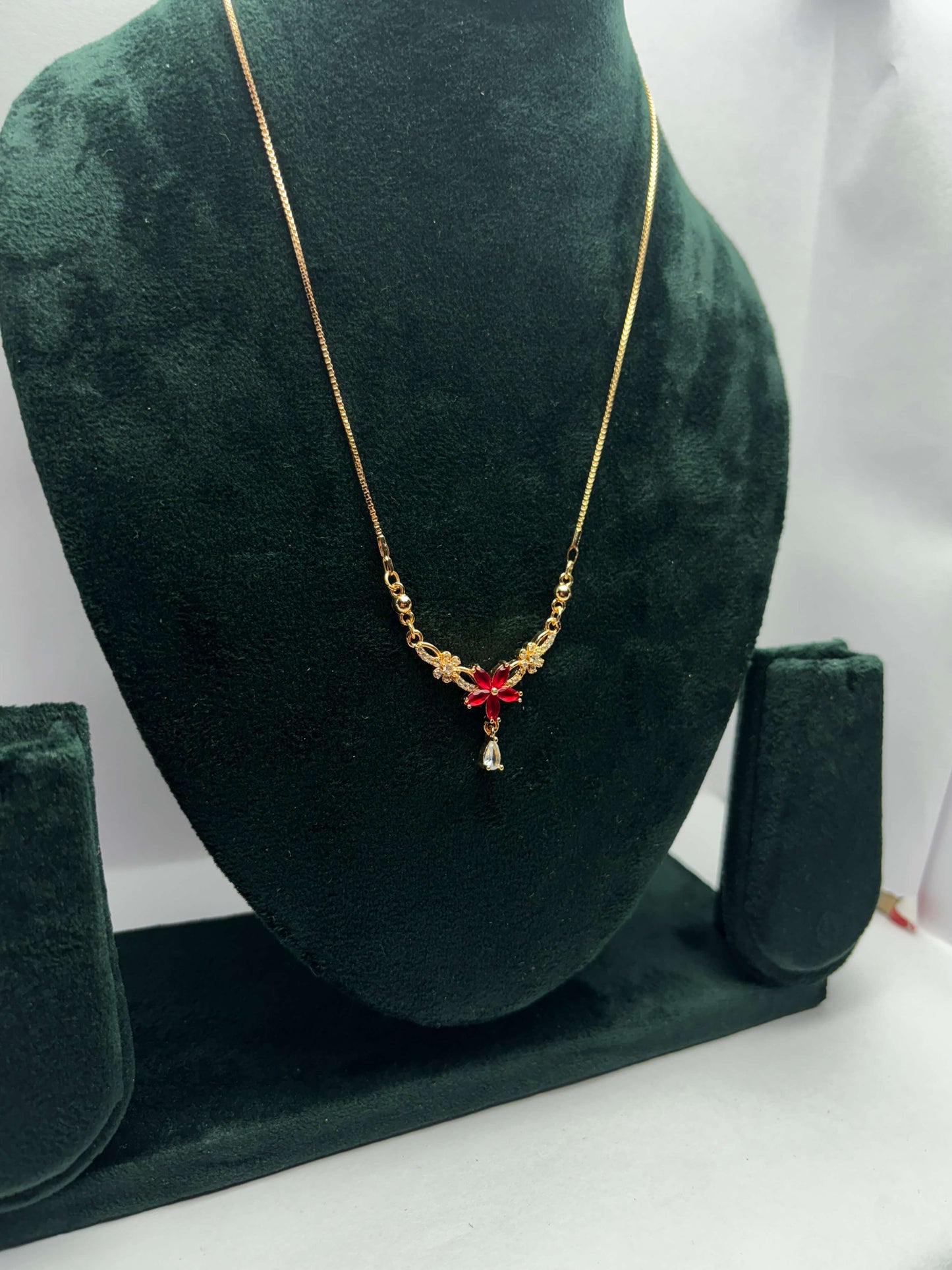 Gold necklace with red flower