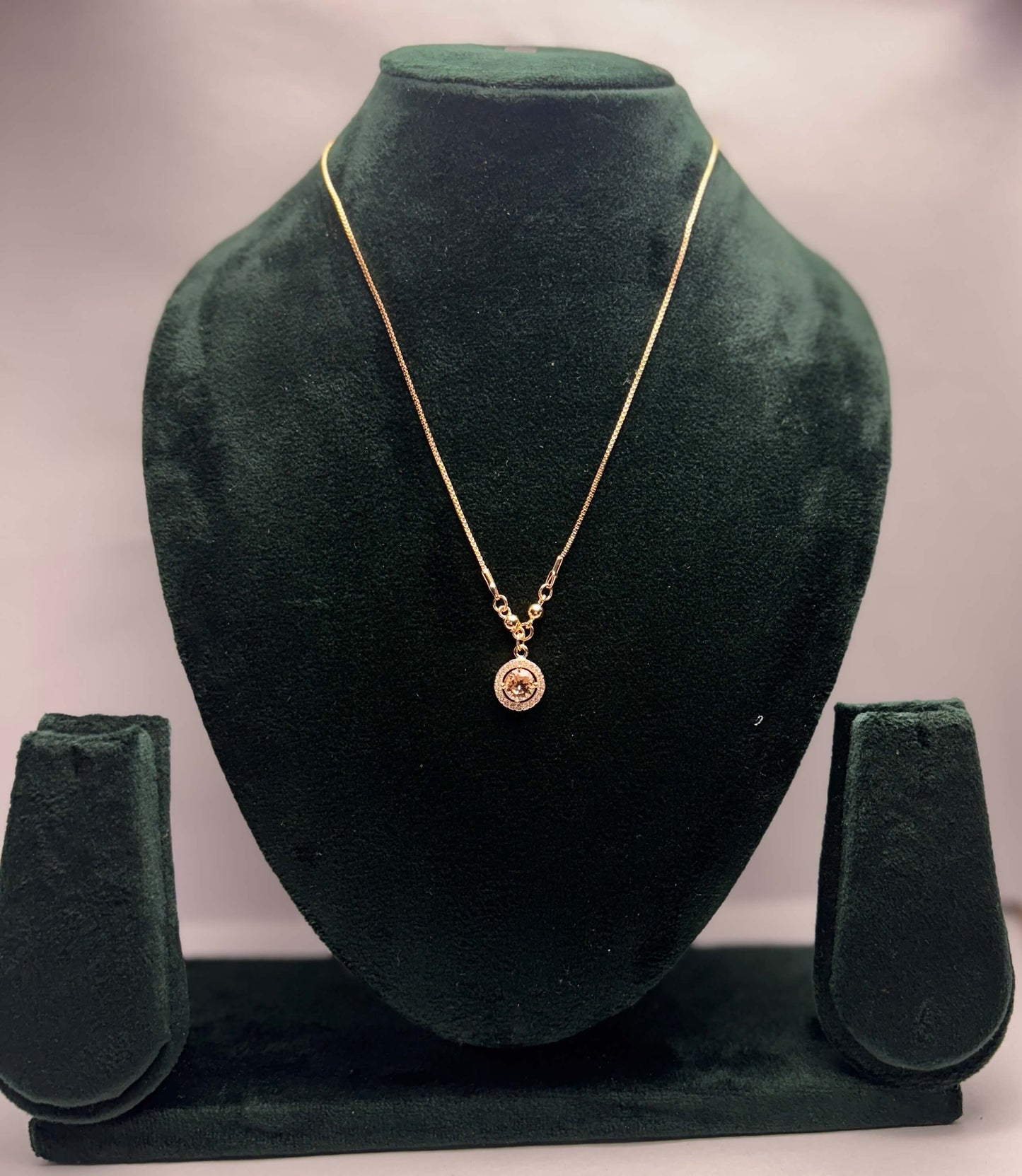 Gold necklace with pendant.