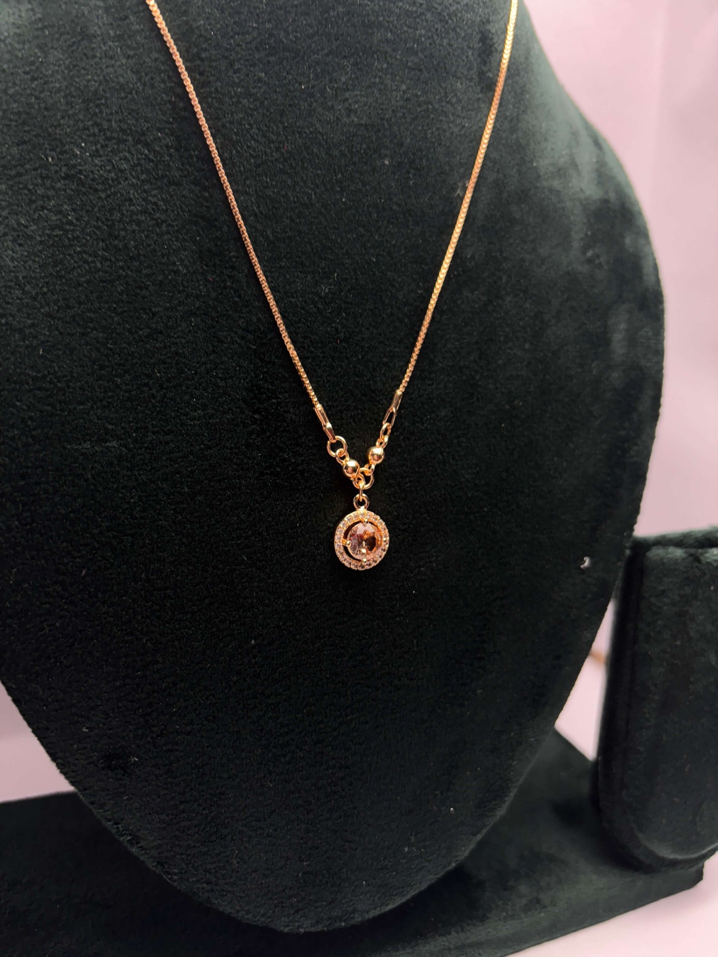 Gold necklace with a pendant.