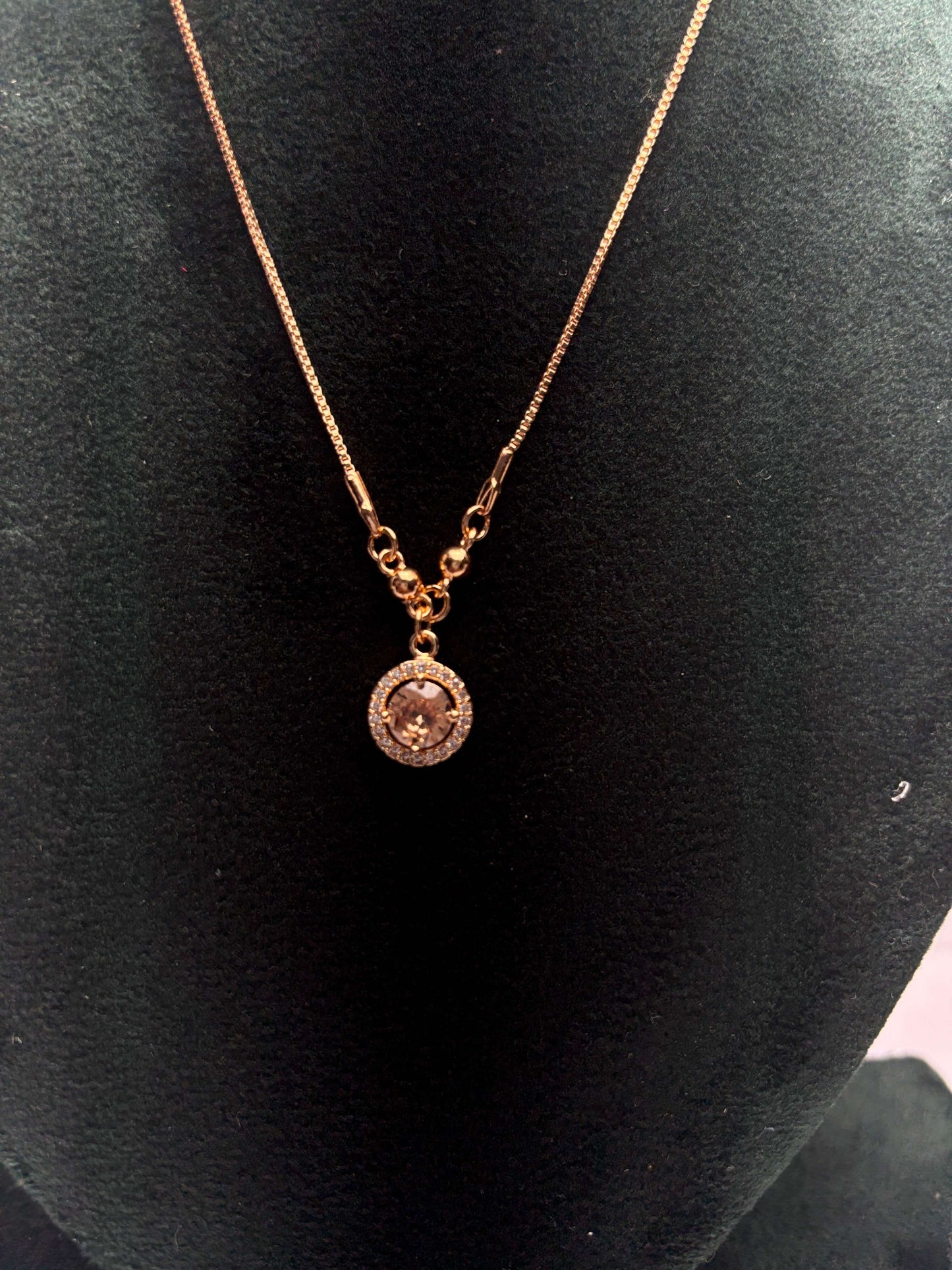 Gold necklace with a pendant.