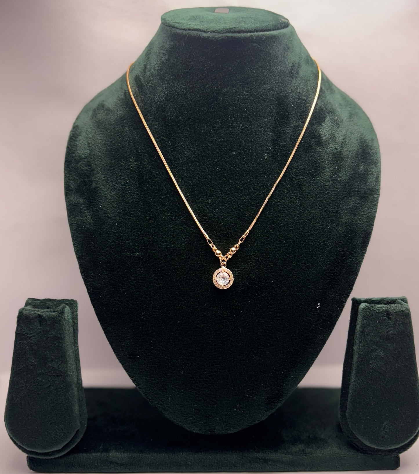 Gold necklace with a pendant.