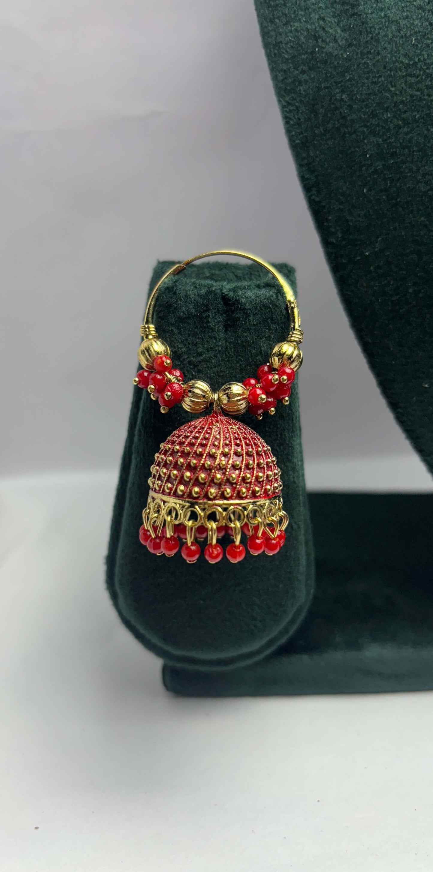 Pair of golden hoop earrings with red beads
