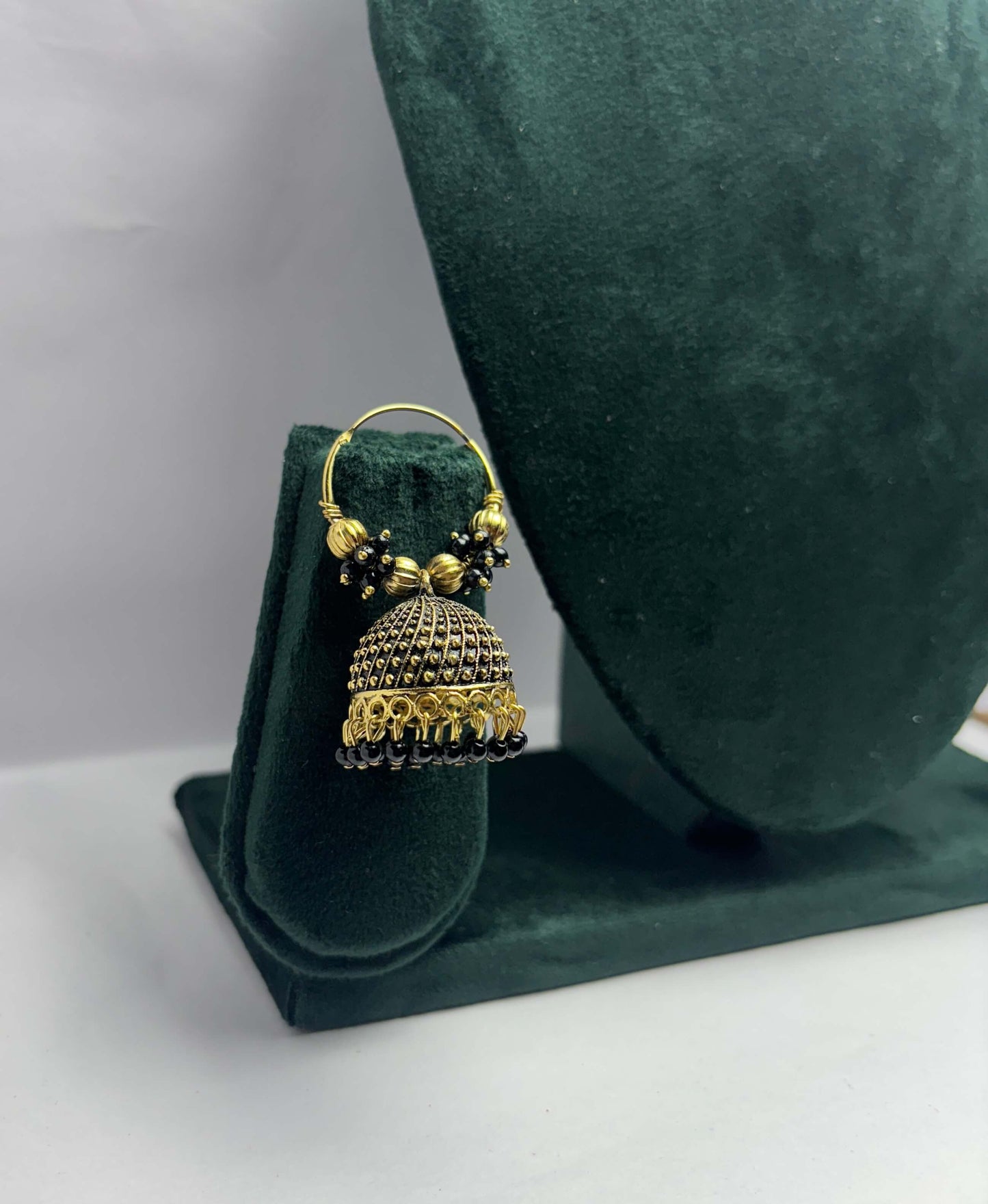 Pair of golden hoop earrings with black beads