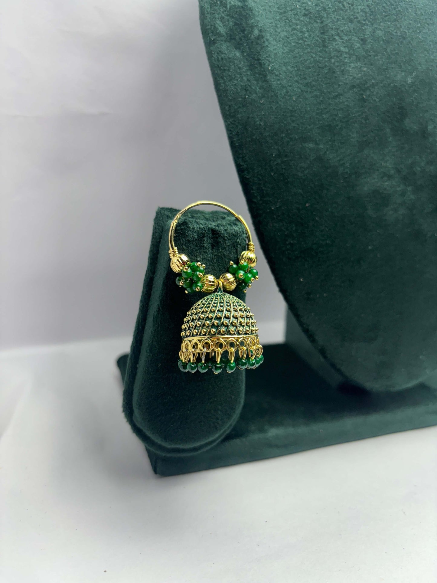 Pair of golden hoop earrings with green beads