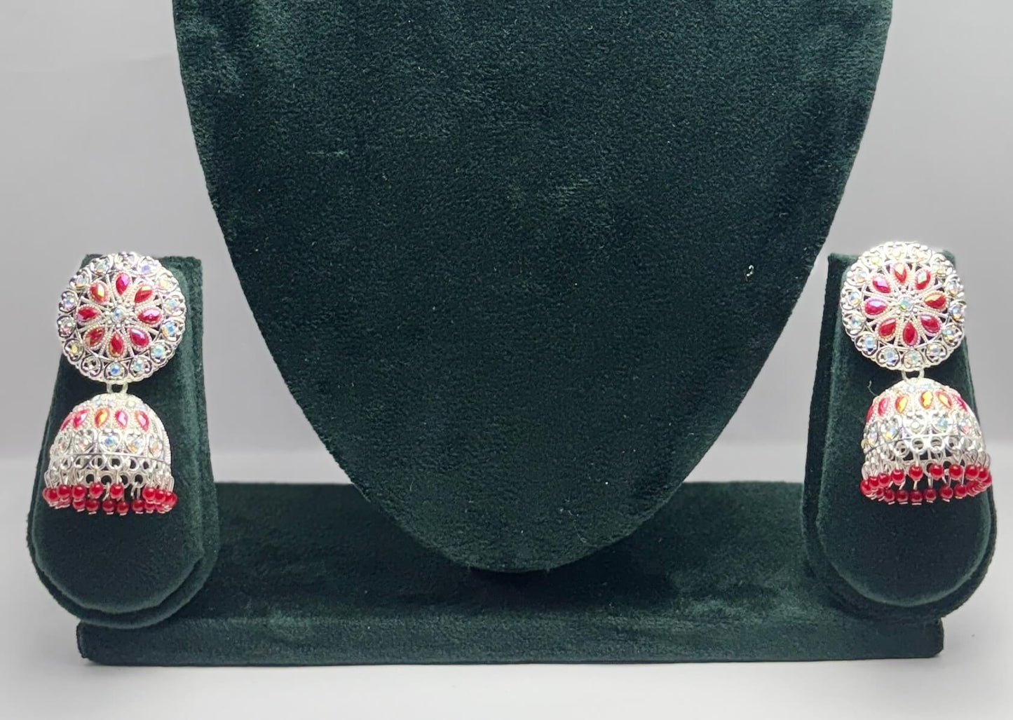 pair of silver oxidized jhumka with red beads