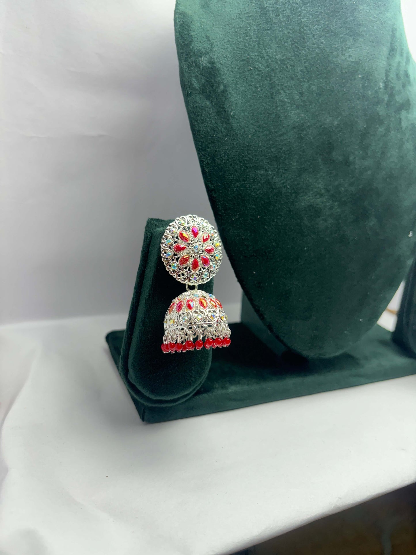 pair of silver oxidized jhumka with red beads