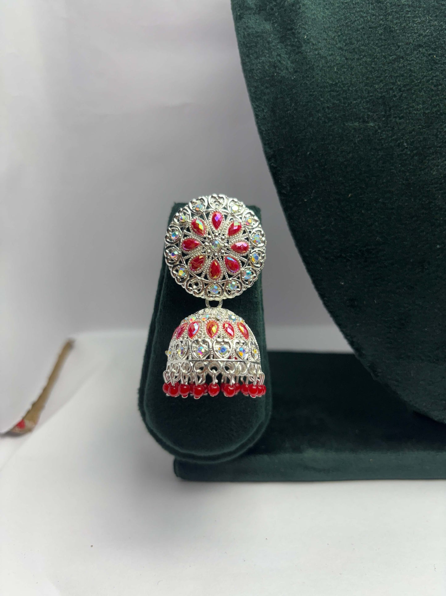pair of silver oxidized jhumka with red beads