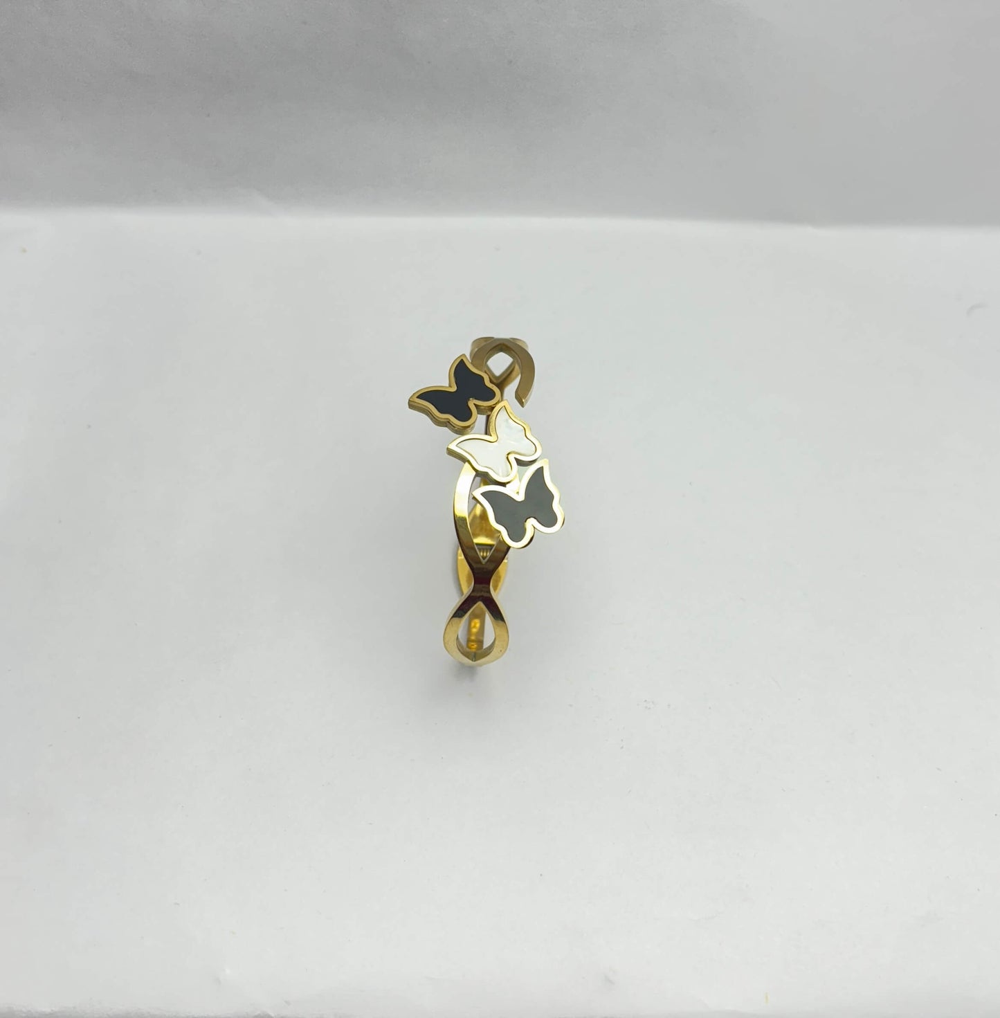Gold and black pendant on a white background