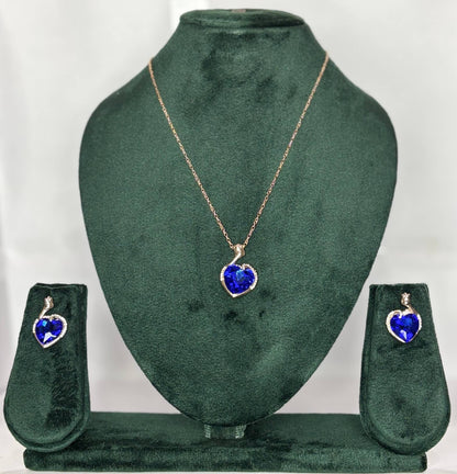 Jewelry set with heart-shaped blue pendant and matching earrings .