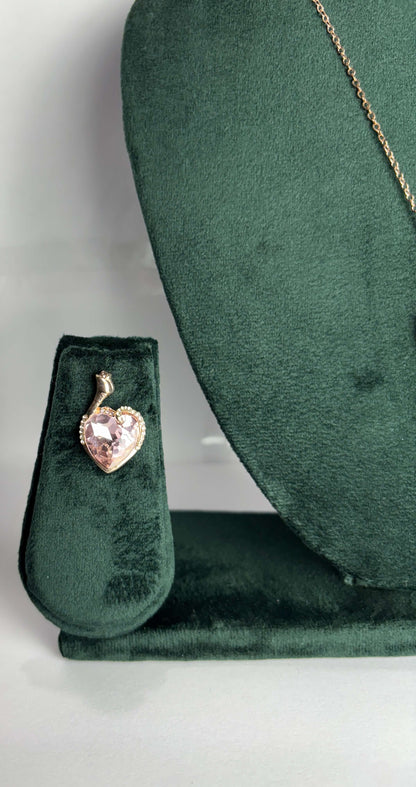 Heart-shaped pink gemstone pendant on a gold chain  