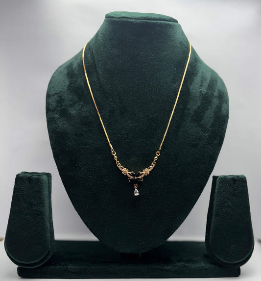 Gold necklace with black flower