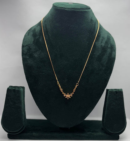 Gold necklace with clear flower