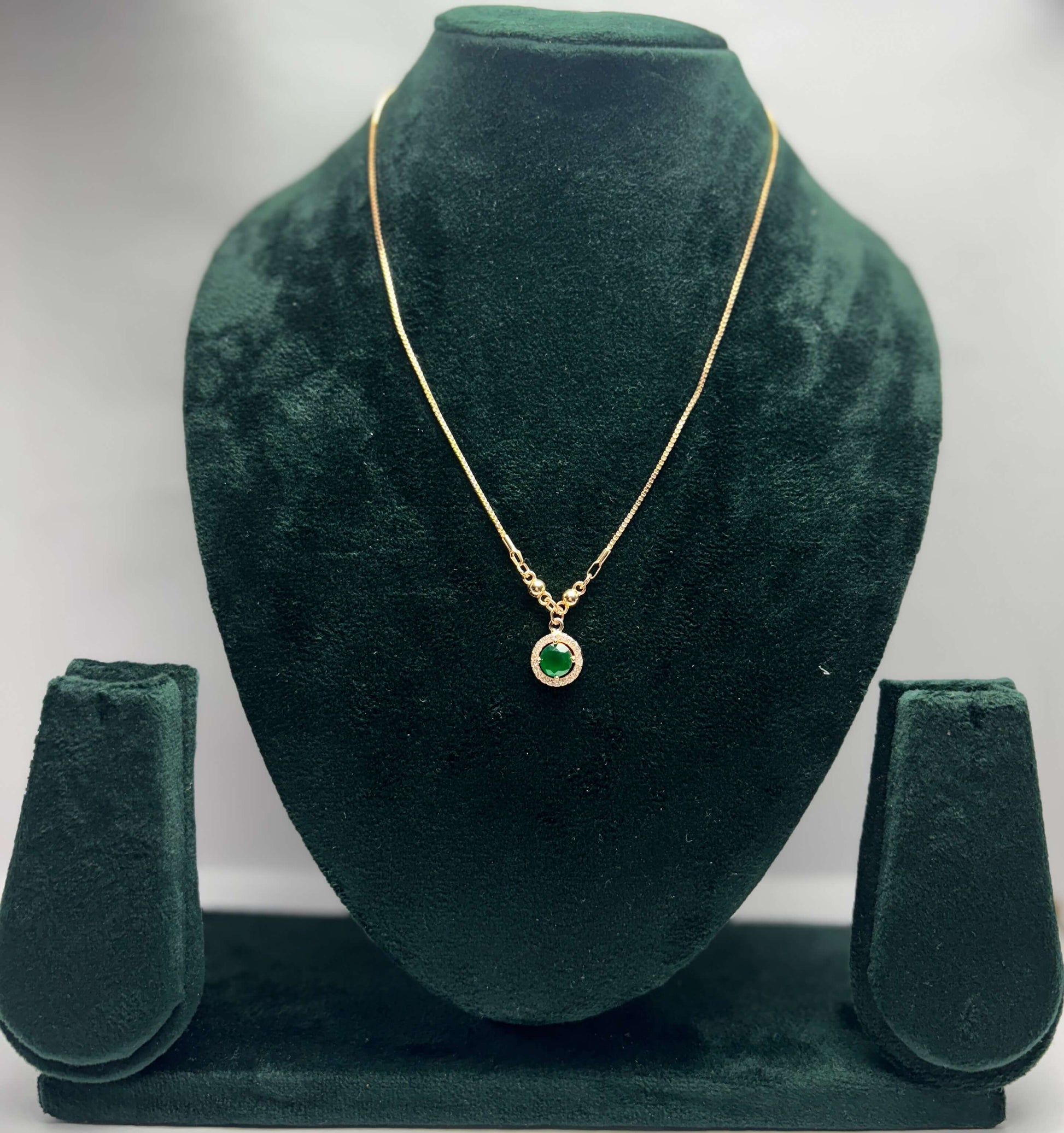 Gold necklace with green gemstone pendant
