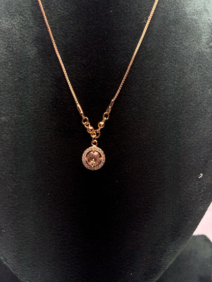 Gold necklace with a pendant.