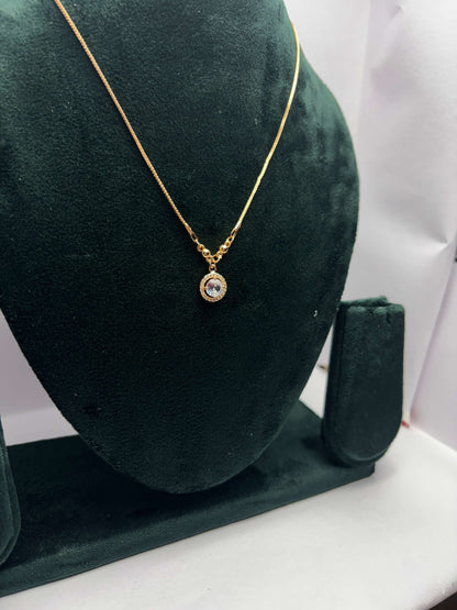 Gold necklace with a pendant.