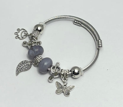 Silver bracelet with charms on a white background